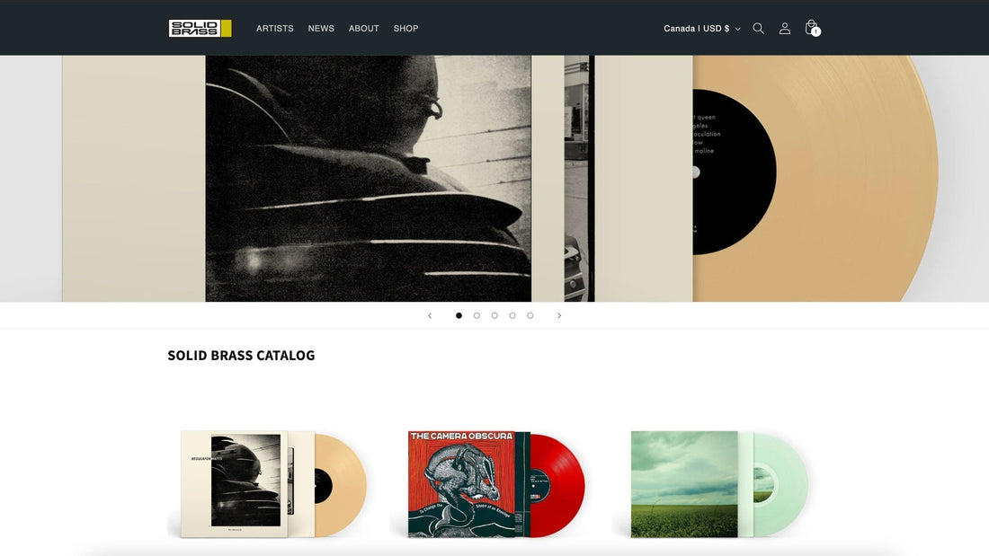 Cropped view of Solid Brass Records homepage showing top level navigation, a hero image rotating banner, and 3 recent LP releases